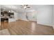 Hardwood floors in the living room adjacent to stairs and a modern kitchen at 6761 Cedar Glen Rd, Peachtree Corners, GA 30360