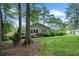Landscaped backyard with mature trees, level lawn and an inviting deck at 1959 Audubon Ne Dr, Atlanta, GA 30329
