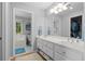Well-lit bathroom featuring a double vanity, a large mirror, and a separate tub/shower area at 1959 Audubon Ne Dr, Atlanta, GA 30329