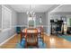 A bright dining room featuring a chandelier, hardwood floors, and large window at 1959 Audubon Ne Dr, Atlanta, GA 30329