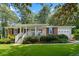 Charming brick home with a covered porch and lush landscaping providing great curb appeal at 1959 Audubon Ne Dr, Atlanta, GA 30329