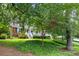 Quaint home with mature trees, green lawn, and a brick facade at 1959 Audubon Ne Dr, Atlanta, GA 30329