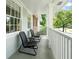 Relaxing front porch with outdoor chairs, white railings, and ample natural light at 1959 Audubon Ne Dr, Atlanta, GA 30329