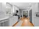 Modern kitchen features stainless appliances, white cabinets, subway tile backsplash, and hardwood floors at 1959 Audubon Ne Dr, Atlanta, GA 30329