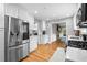 A modern kitchen with stainless steel appliances, white cabinetry, and hardwood floors at 1959 Audubon Ne Dr, Atlanta, GA 30329