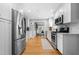 A modern kitchen with stainless steel appliances, white cabinetry, and hardwood floors at 1959 Audubon Ne Dr, Atlanta, GA 30329