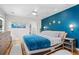 Stylish main bedroom features a striking blue accent wall, modern furnishings, and ample natural light at 1959 Audubon Ne Dr, Atlanta, GA 30329