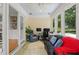 Bright sunroom featuring large windows, a comfortable seating area, and space for an office at 1959 Audubon Ne Dr, Atlanta, GA 30329