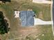 Aerial view of home's backyard featuring patio, lawn, and driveway at 293 Ironwood Dr, Stockbridge, GA 30281