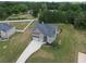Aerial view of a two-story home showcasing the roof, driveway, and surrounding landscaping at 293 Ironwood Dr, Stockbridge, GA 30281