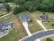 Stunning aerial view of a two-story home featuring a spacious lawn and an extended driveway to a two-car garage at 293 Ironwood Dr, Stockbridge, GA 30281