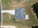 An aerial view of a house presenting its backyard patio, spacious lawn, and landscaping details at 293 Ironwood Dr, Stockbridge, GA 30281