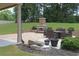 Inviting backyard featuring an outdoor fireplace, patio with furniture, and lush landscaping at 293 Ironwood Dr, Stockbridge, GA 30281