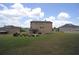 A vast backyard showing the house's rear elevation, with lush lawn and outdoor entertainment space at 293 Ironwood Dr, Stockbridge, GA 30281