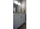 Modern powder room featuring a stylish vanity with gold fixtures and accent wall at 293 Ironwood Dr, Stockbridge, GA 30281