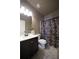 Neutral bathroom featuring a dark vanity and a shower with a patterned curtain at 293 Ironwood Dr, Stockbridge, GA 30281