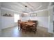 Inviting dining room with tray ceiling, modern lighting, and elegant decorative features at 293 Ironwood Dr, Stockbridge, GA 30281