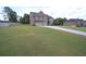Traditional two-story home boasting a well-manicured lawn and a long driveway leading to a three-car garage at 293 Ironwood Dr, Stockbridge, GA 30281