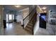 Inviting foyer with staircase, tiled floors, and a modern aquarium at 293 Ironwood Dr, Stockbridge, GA 30281