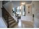 Entryway with staircase leading to living area with high ceilings and large windows at 293 Ironwood Dr, Stockbridge, GA 30281