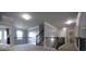 Hallway featuring a carpeted floor, railing and large window at 293 Ironwood Dr, Stockbridge, GA 30281