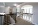 Hallway with decorative railing, arches, and abundant natural light at 293 Ironwood Dr, Stockbridge, GA 30281