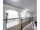 Upper hallway with decorative railing and archways, offering a view of the main floor below at 293 Ironwood Dr, Stockbridge, GA 30281