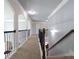 Upper hallway with decorative iron railing overlooking the main floor and staircase at 293 Ironwood Dr, Stockbridge, GA 30281