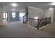 Spacious landing area boasting carpeted floors, natural light, and stylish staircase at 293 Ironwood Dr, Stockbridge, GA 30281