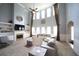 Bright living room with soaring ceilings, a fireplace, built-in shelves, and large windows at 293 Ironwood Dr, Stockbridge, GA 30281
