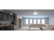 Spacious recreation room features plush carpet, recessed lighting, and dark wood cabinets with a mini-fridge at 293 Ironwood Dr, Stockbridge, GA 30281