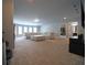 Spacious living area boasts carpeted floors, ample seating, and recessed lighting at 293 Ironwood Dr, Stockbridge, GA 30281
