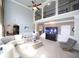 Well-lit living room with a large aquarium, high ceilings, and comfortable furnishings at 293 Ironwood Dr, Stockbridge, GA 30281