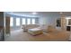 Large living area boasts carpeted floors, natural light, and comfortable sectional couch at 293 Ironwood Dr, Stockbridge, GA 30281