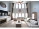Bright living room with soaring ceilings, fireplace, built-ins, and large sectional sofa at 293 Ironwood Dr, Stockbridge, GA 30281