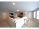 Bright living room with plush carpeting, large sectional sofa, and kitchenette area at 293 Ironwood Dr, Stockbridge, GA 30281