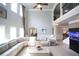 Open-concept living area with fireplace, high ceilings, and access to dining and staircase at 293 Ironwood Dr, Stockbridge, GA 30281