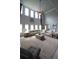 Open concept living area with high ceilings, large windows, and comfortable sectional at 293 Ironwood Dr, Stockbridge, GA 30281