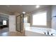 Clean and modern main bathroom with a large tub, glass shower, and lots of light at 293 Ironwood Dr, Stockbridge, GA 30281