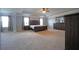 Bright and spacious main bedroom featuring neutral paint, tray ceiling, and dark furniture at 293 Ironwood Dr, Stockbridge, GA 30281