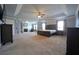 Spacious main bedroom featuring a fireplace, sitting area, and a tray ceiling with fan at 293 Ironwood Dr, Stockbridge, GA 30281