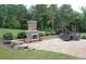 This backyard patio features a stone fireplace and an outdoor dining set, perfect for entertaining at 293 Ironwood Dr, Stockbridge, GA 30281