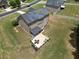 Drone photo of the back of house reveals a covered patio area ideal for enjoying the outdoors at 293 Ironwood Dr, Stockbridge, GA 30281