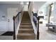 Carpeted stairs with decorative iron railing leading to the main floor and living area at 293 Ironwood Dr, Stockbridge, GA 30281