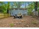 Large backyard with deck, firepit, and mature trees for privacy, creating a serene outdoor space at 3408 Phillips Cir, Decatur, GA 30032