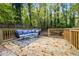 Back deck with outdoor seating and serene view of mature trees and garden at 3408 Phillips Cir, Decatur, GA 30032