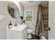 Cozy bathroom featuring a single vanity, round mirror, and shower-tub combination at 3408 Phillips Cir, Decatur, GA 30032