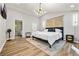 Tranquil main bedroom featuring a vaulted ceiling, a modern chandelier, and minimalist decor at 3408 Phillips Cir, Decatur, GA 30032