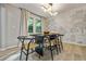 Well-lit dining area featuring a modern light fixture and decorative wallpaper that brings the outdoors in at 3408 Phillips Cir, Decatur, GA 30032