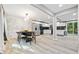 Open floor plan between dining and kitchen showcasing white cabinets and stainless steel appliances at 3408 Phillips Cir, Decatur, GA 30032